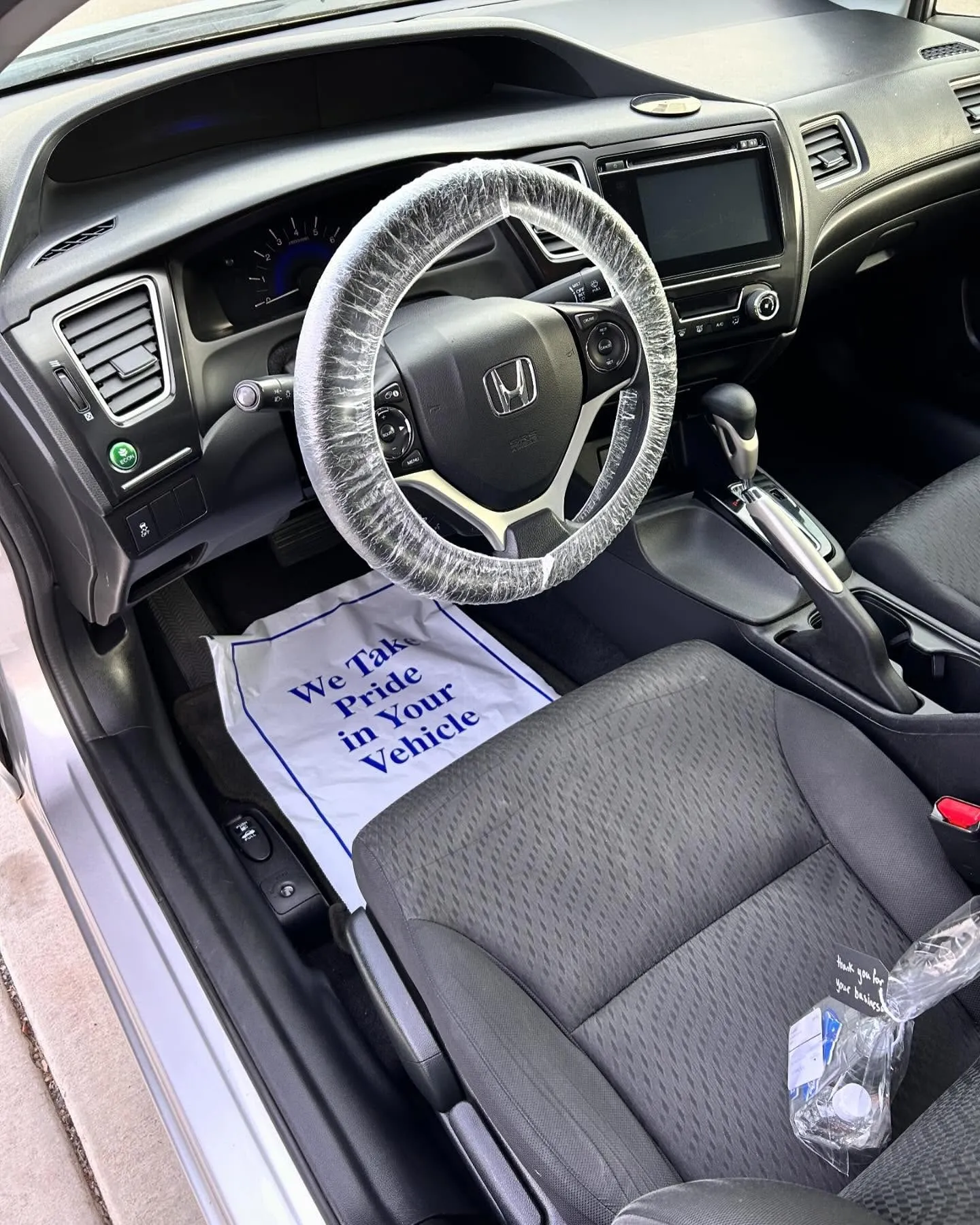 After: the driver footwell and seat of a Honda Civic on an interior detail