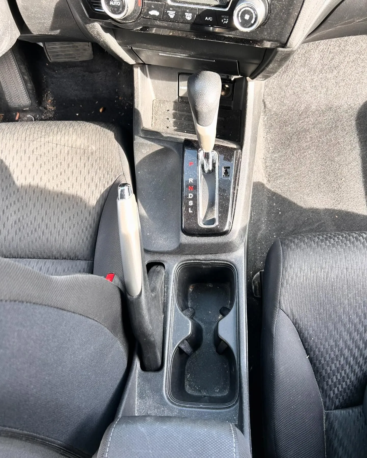 Before: the center console and cup holders of the same Honda Civic
