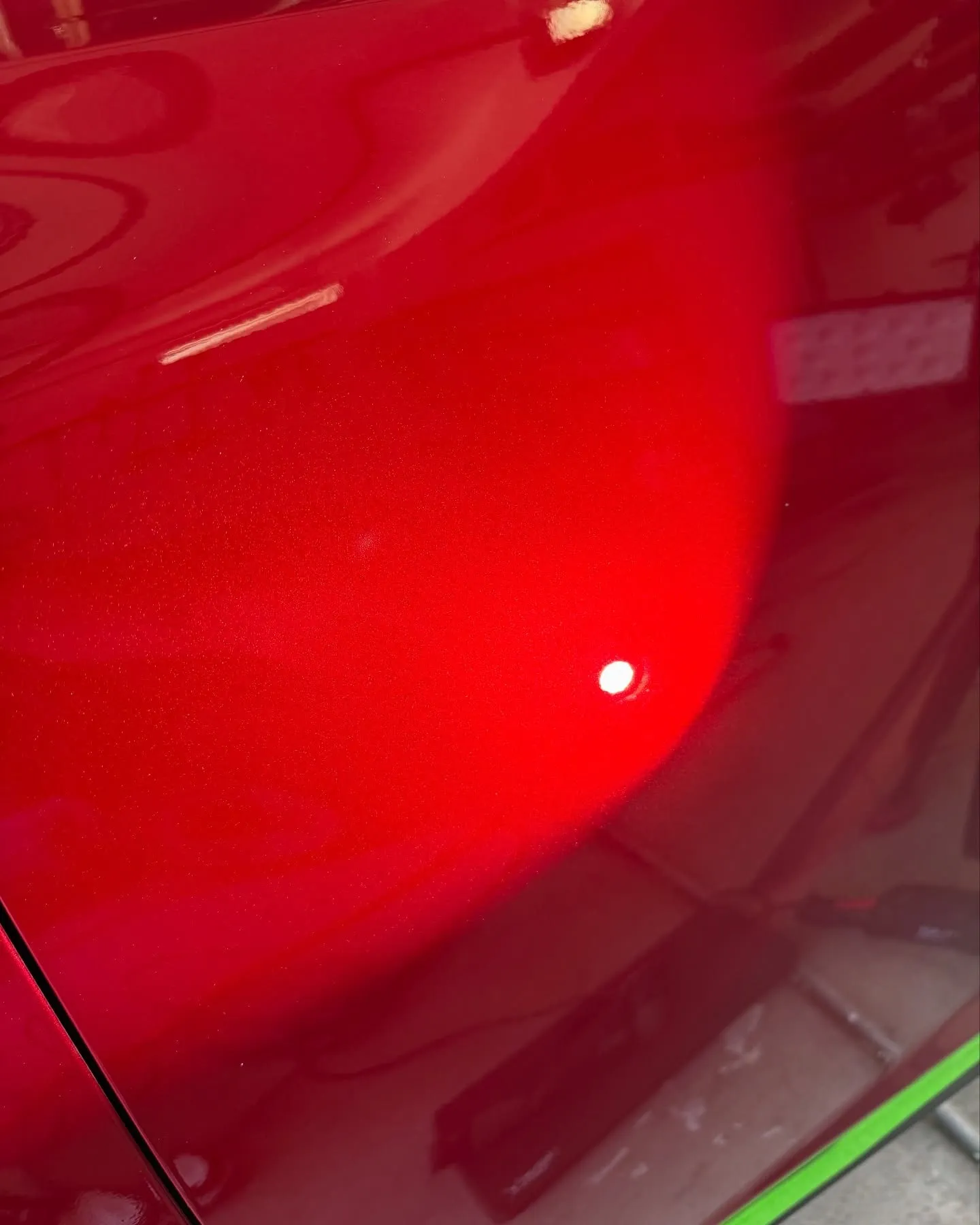 After: the door of a red Lexus NX under direct sun