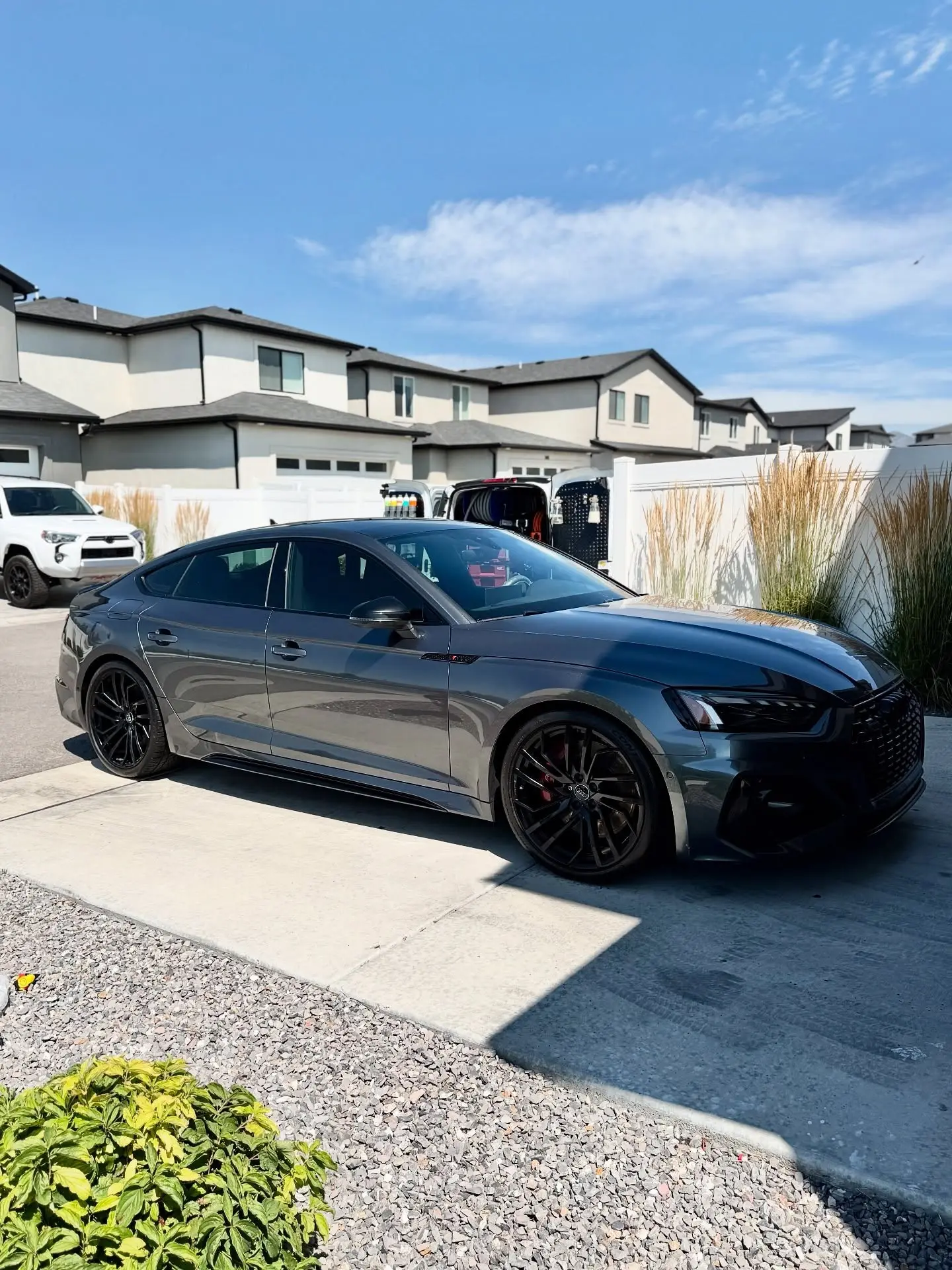 A gray Audi RS5 freshly detailed in a Murray area driveway