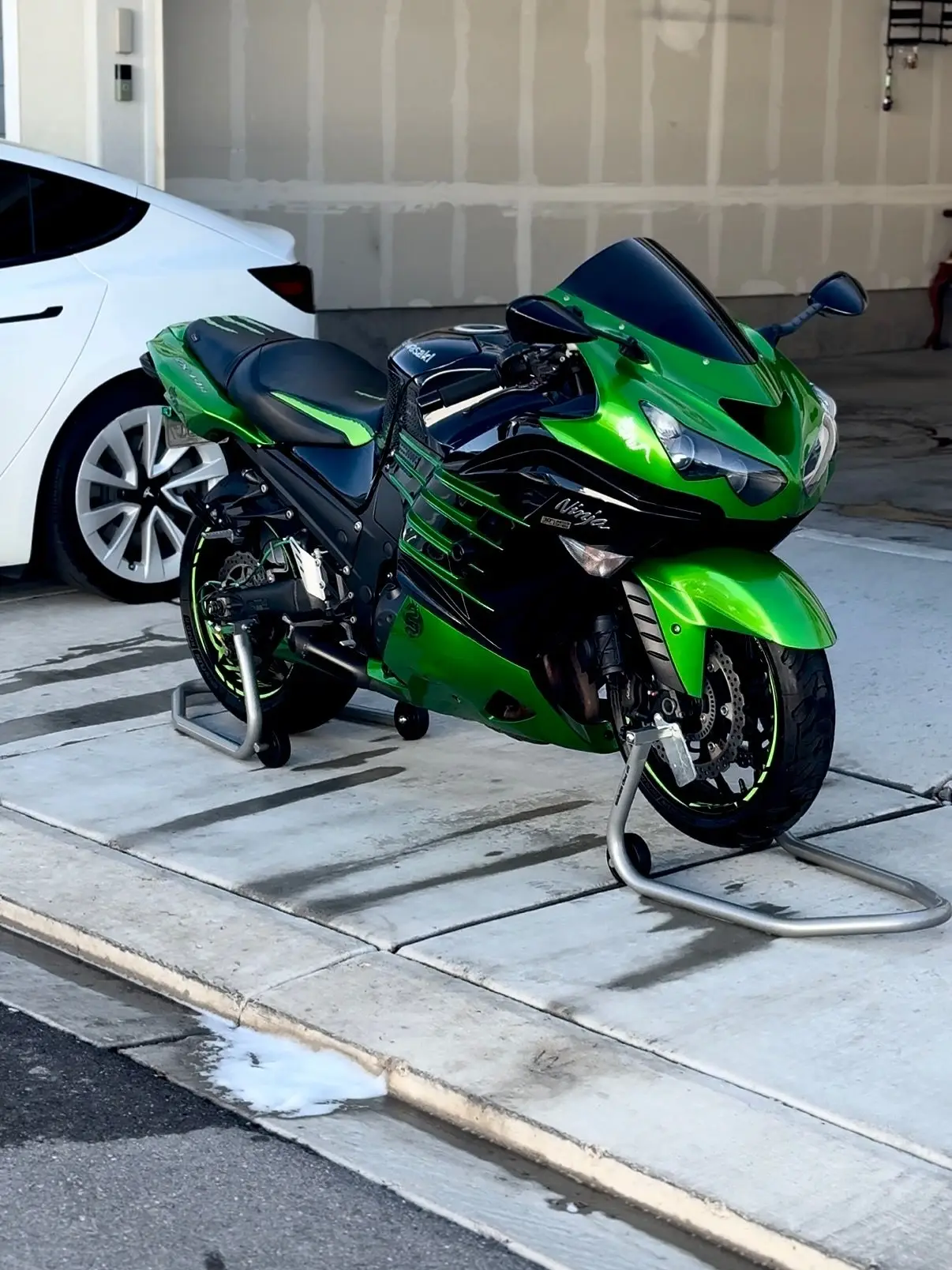 A green Kawasaki Ninja ZX-14R on a stand after detailing