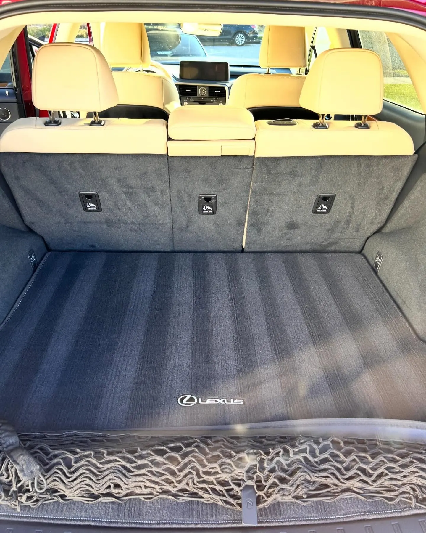 The tan rear seats and cargo area of a Lexus RX after an interior detail